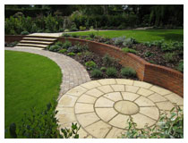 Circular sitting area (patio) and view across the garden – after design, construction and planting.